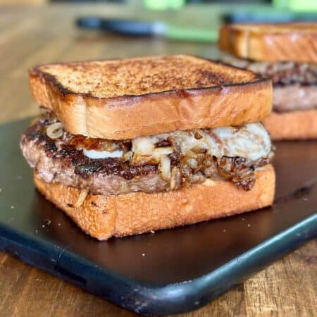 French onion patty melt burger with caramelized onions and Swiss cheese