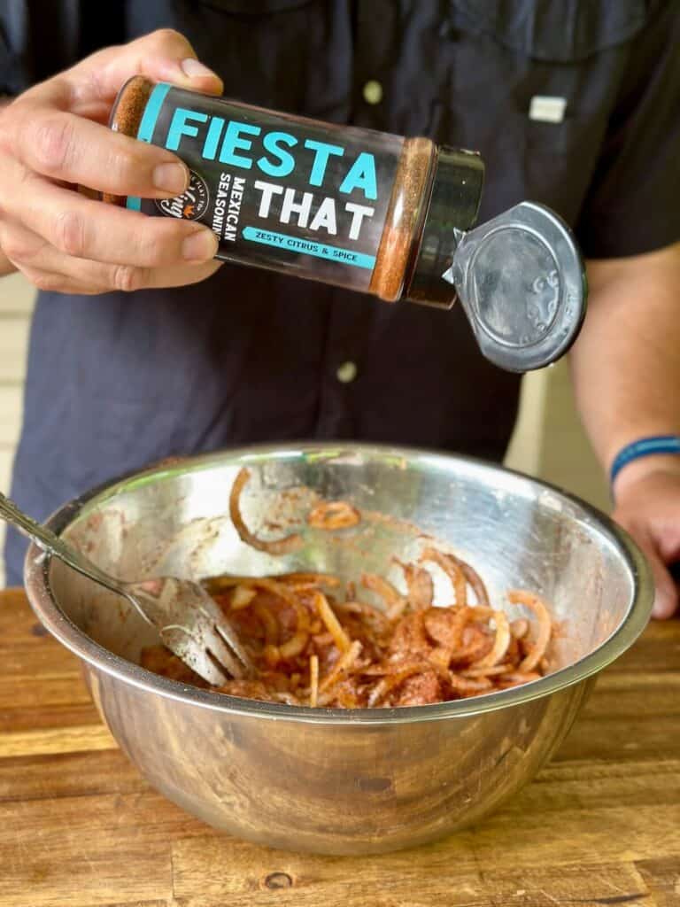 marinating chicken in a Mexican seasoning blend in a bowl