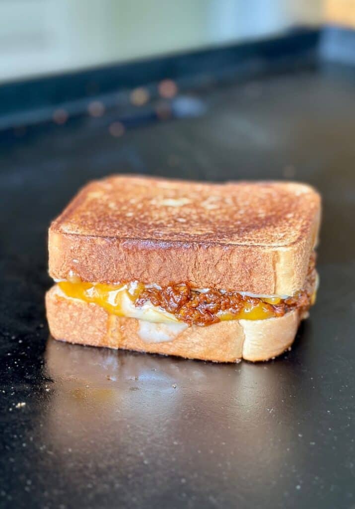 sloppy joe grilled cheese sandwich cooking on a griddle