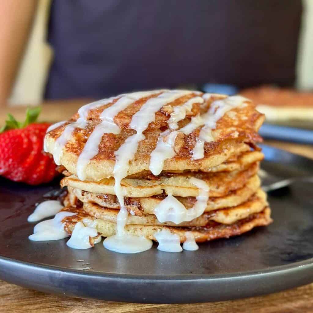 cinnamon roll pancakes with cream cheese icing drizzle