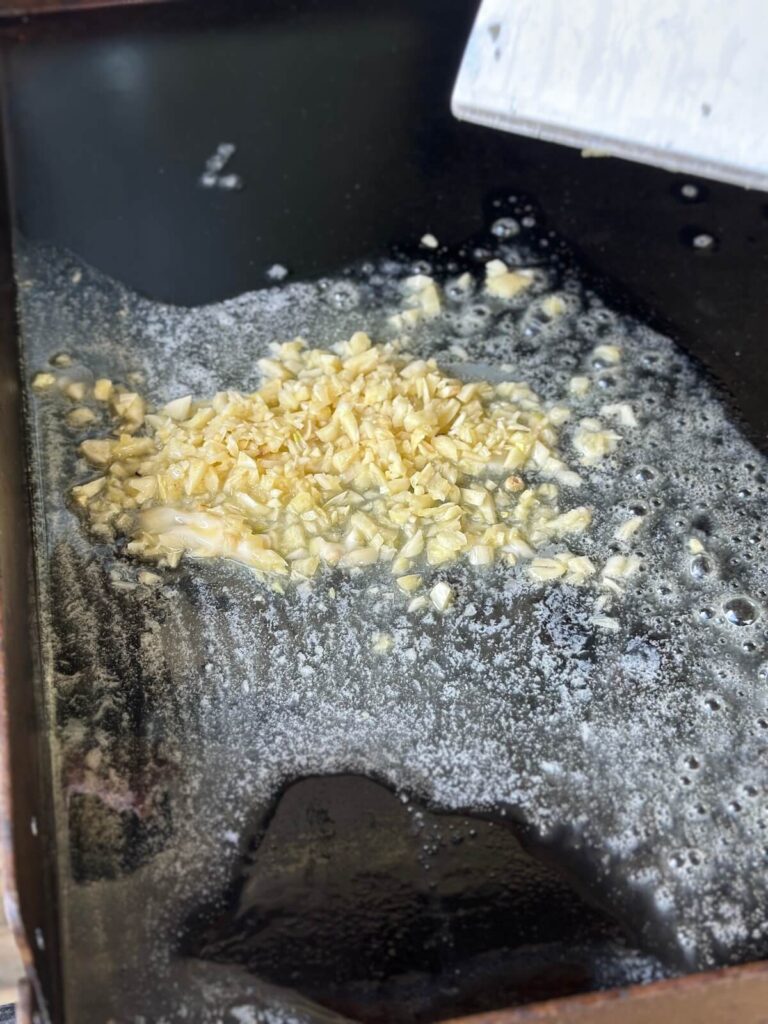 sautéing minced garlic in butter