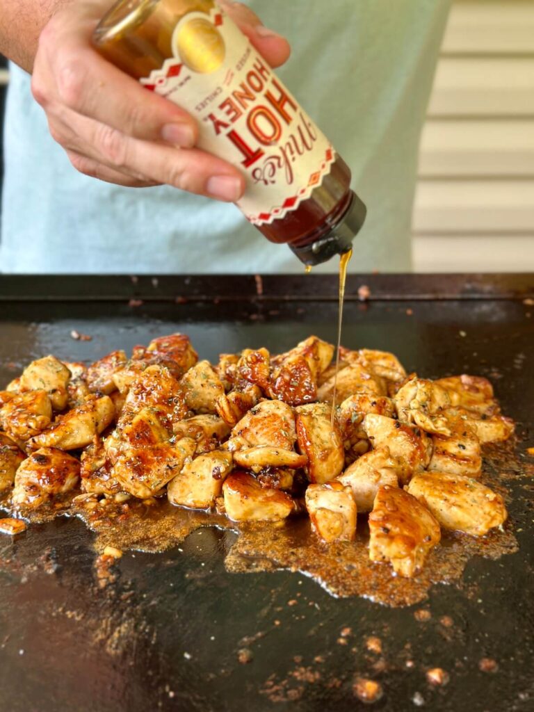 adding honey to garlic butter chicken bites