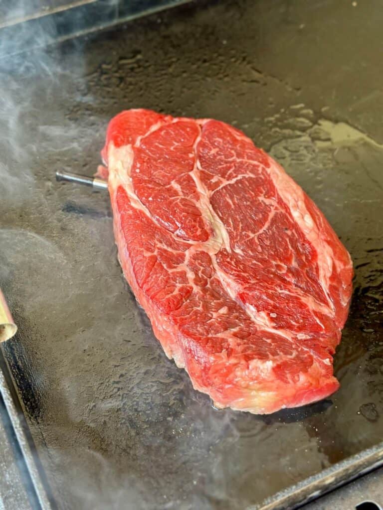 searing a beef chuck roast on a griddle