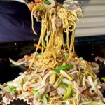making beef chow mein on a griddle