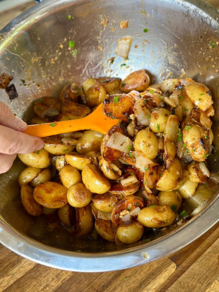 tossing griddle potatoes with cowboy butter