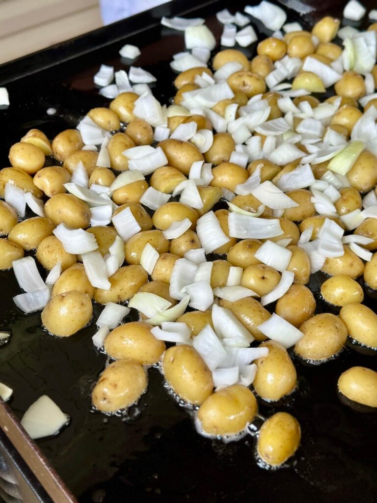 cooking potatoes and onions on a Blackstone griddle