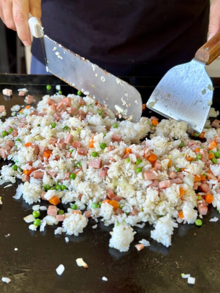 making fried rice with spam on a griddle