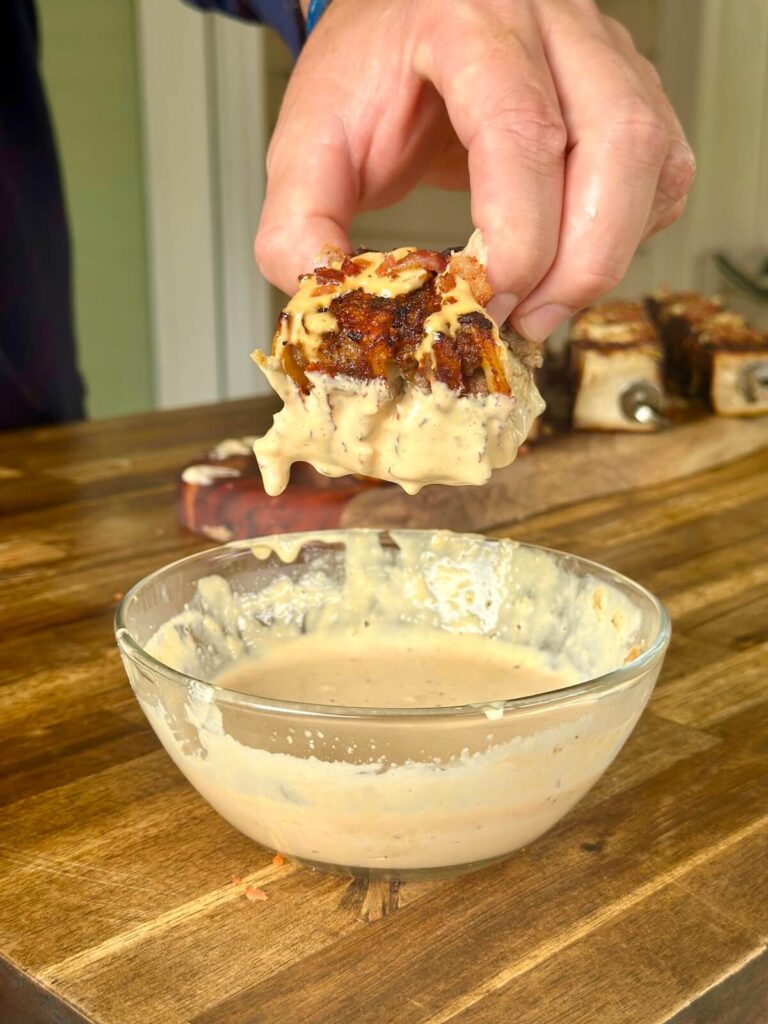 dipping smashburger tortilla skewer into smashburger sauce