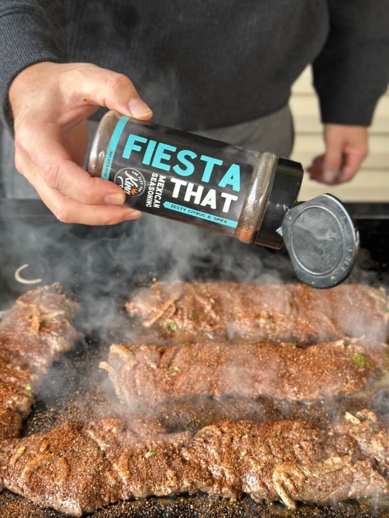seasoning carne asada skirt steak with a Mexican seasoning