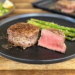 filet mignon cut in half on a plate