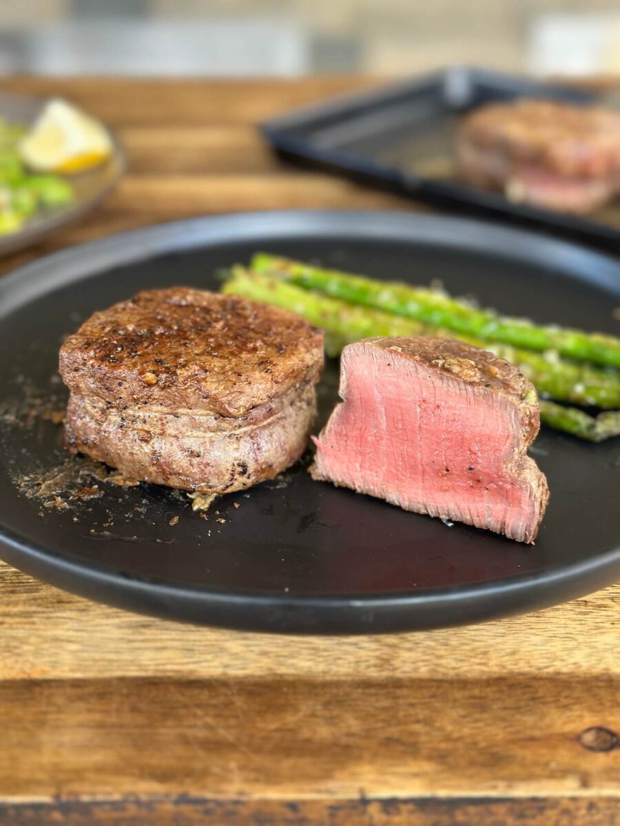 filet mignon cut in half on a plate
