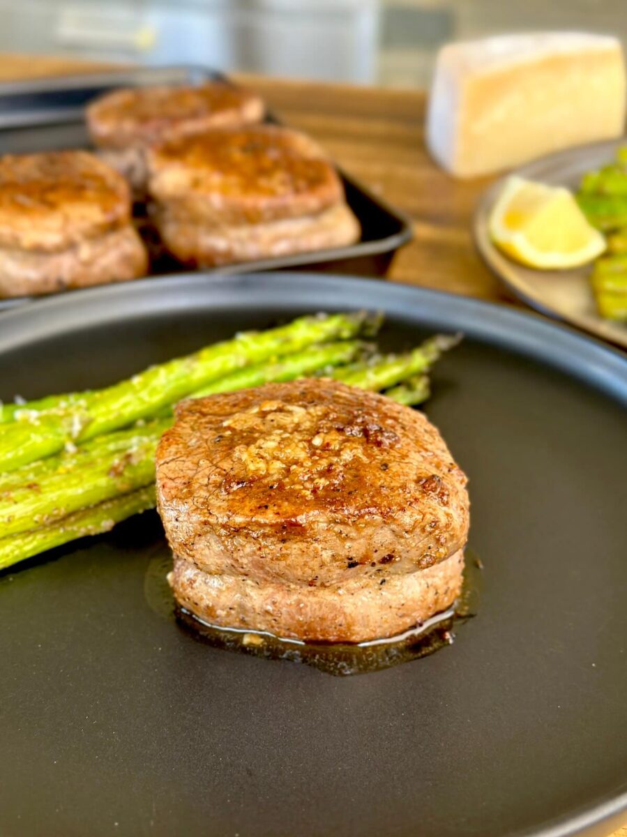 filet mignon on a plate with asparagus