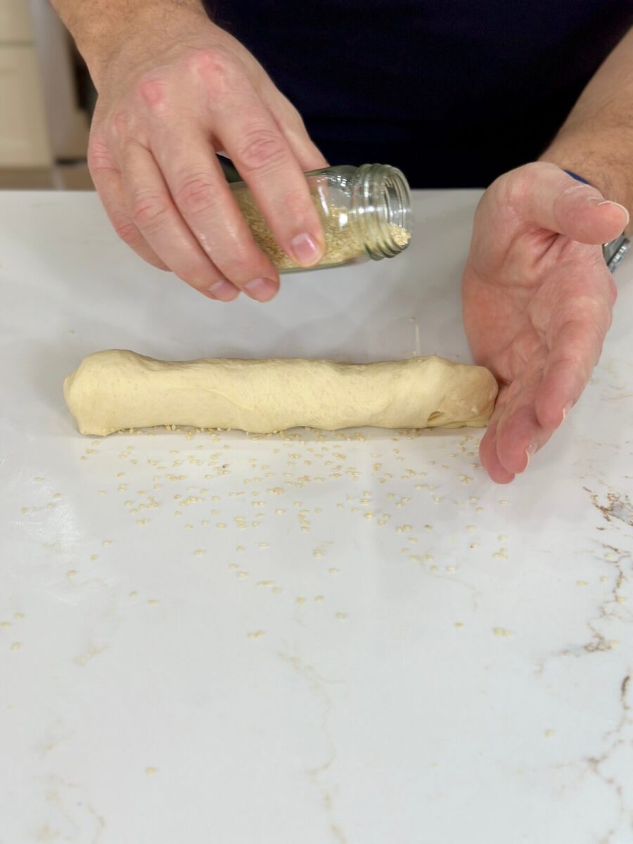rolling out dough for hoagie rolls
