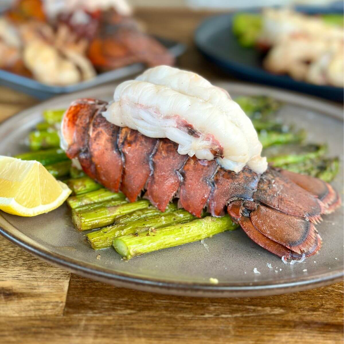 lobster tails on Blackstone served with asparagus