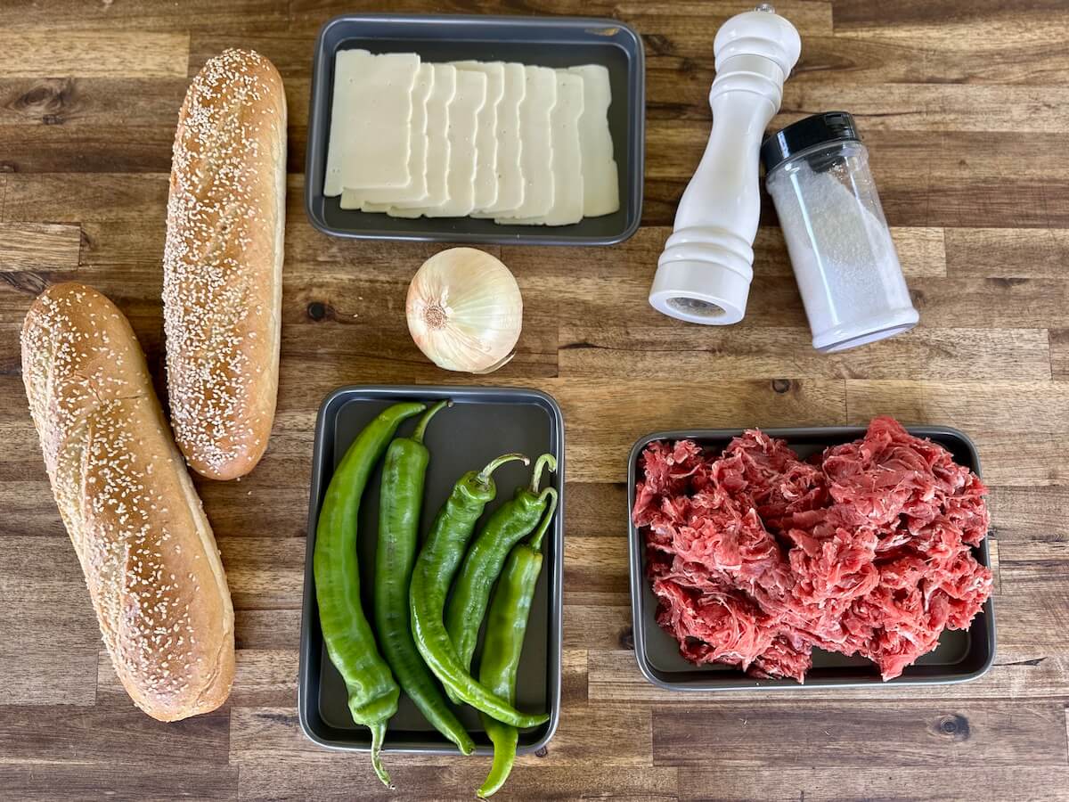 shaved ribeye, hoagie rolls, long hot peppers, onion, and white American cheese