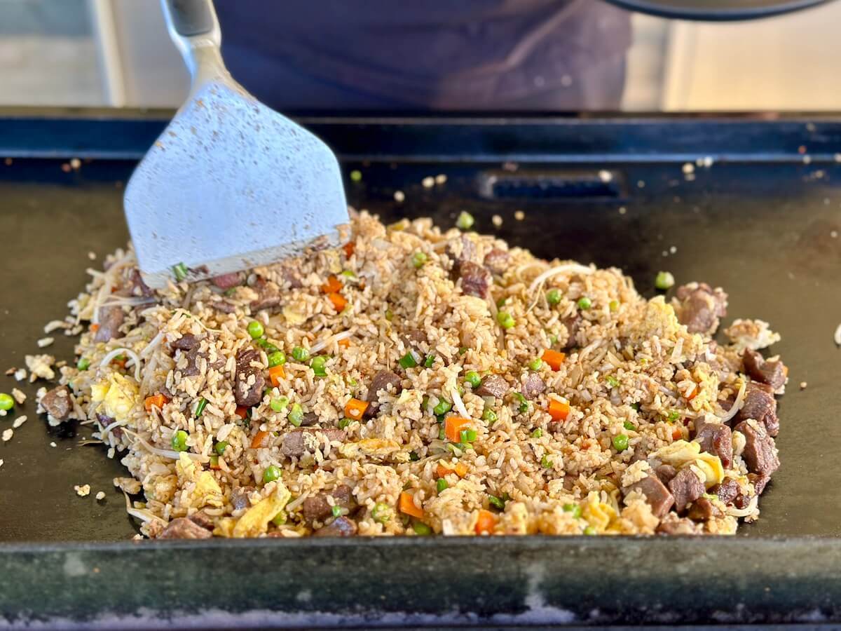 cooking steak fried rice on a Blackstone griddle