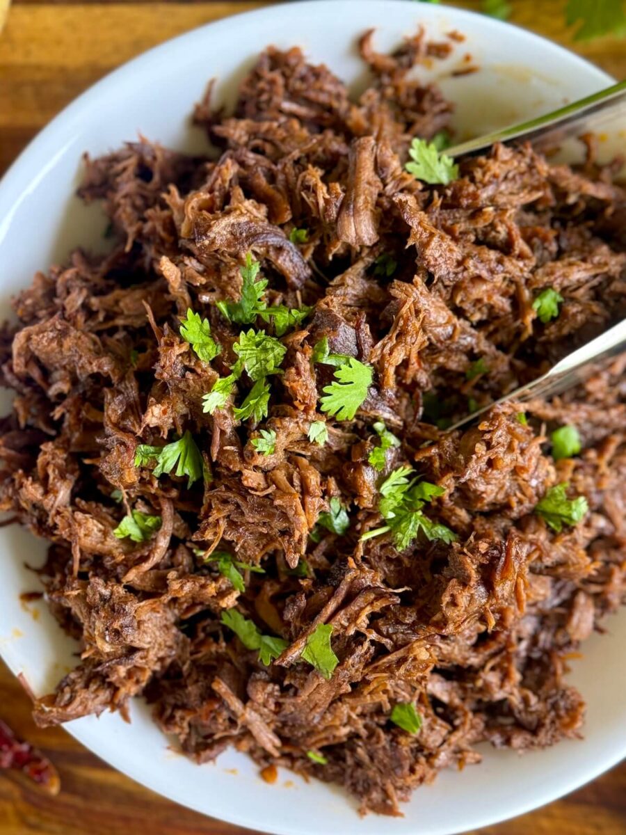beef birria meat garnished with chopped cilantro