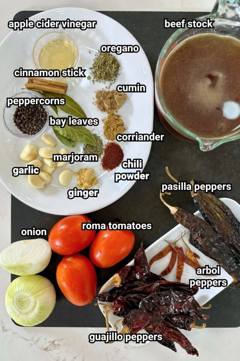 ingredients for beef birria measured out on a cutting board