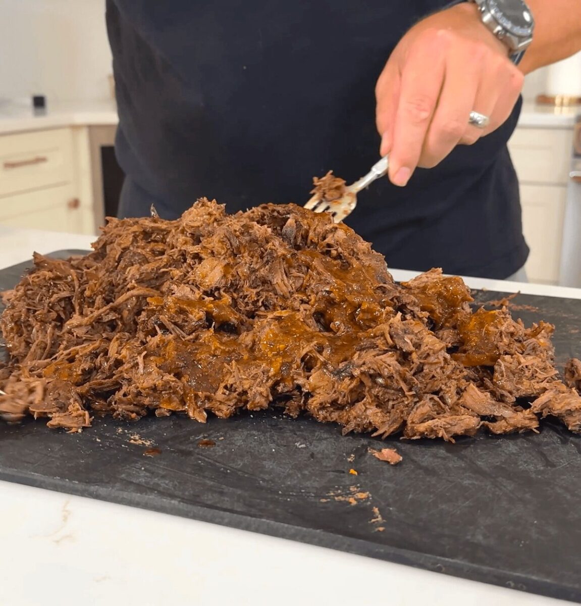shredding Mexican chuck roast with a fork
