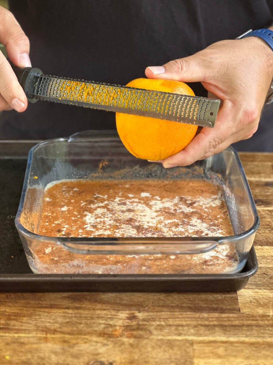 using a microplane to zest an orange for French toast batter