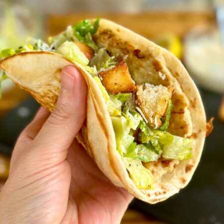chicken Caesar smash taco with chicken, lettuce, croutons and Caesar dressing in a tortilla