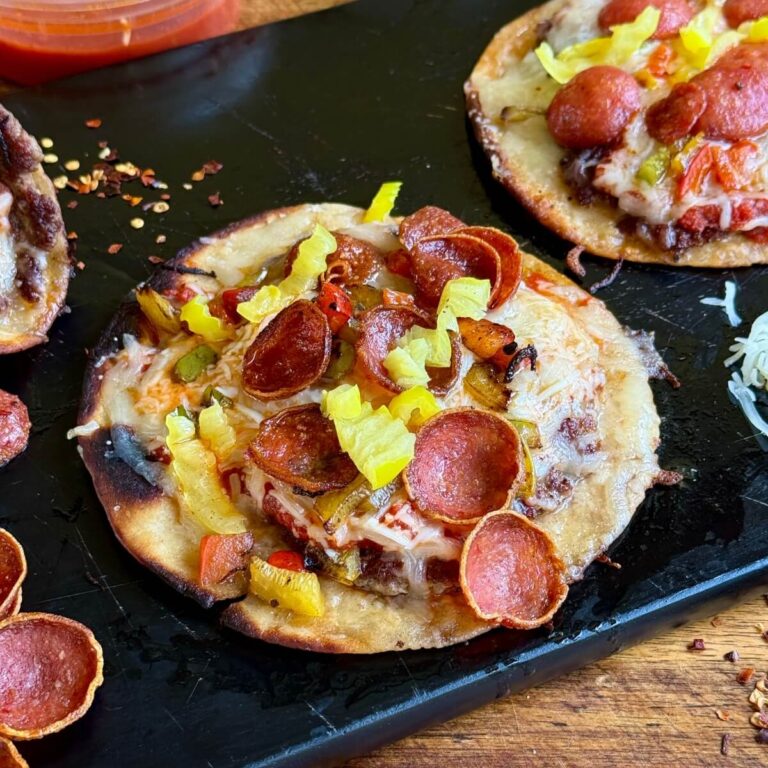 pizza smash tacos on a cutting board with mozzarella cheese and banana peppers