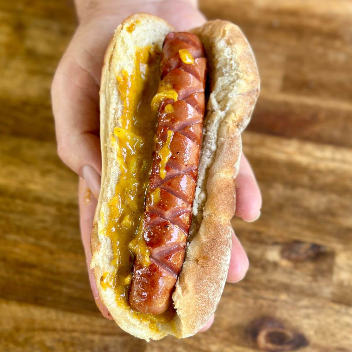 hot dog with a sweet onion mustard sauce on a bun
