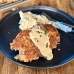 country fried steak with gravy and mashed potatoes on a plate