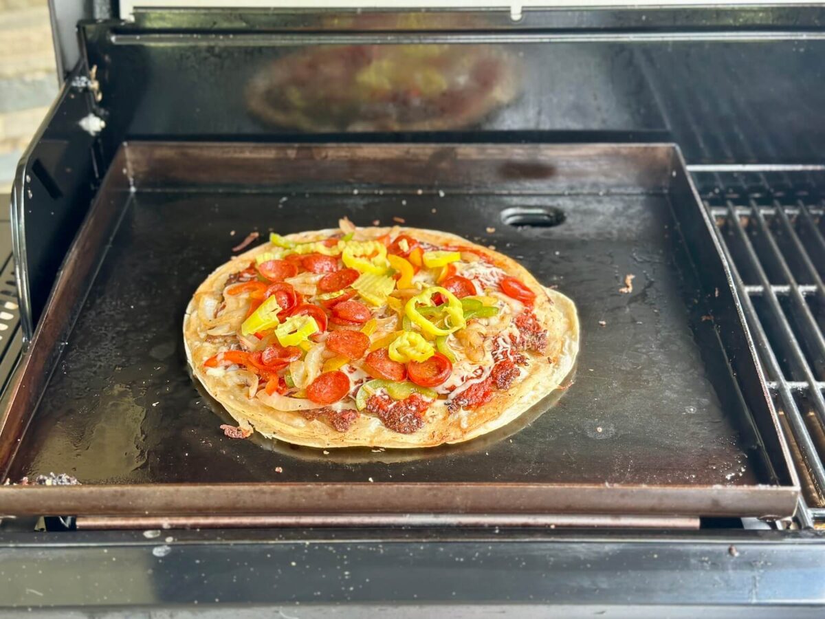 cooking a tortilla pizza on a Blackstone griddle