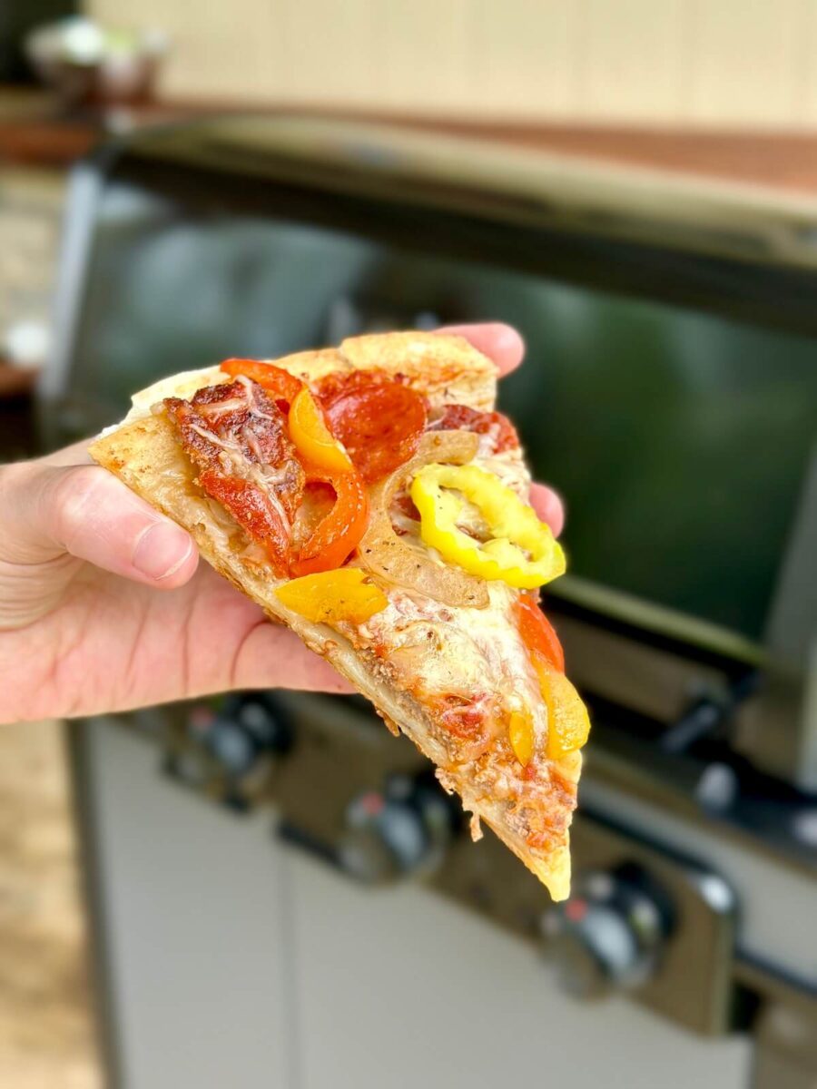 a slice of tortilla pizza with pepperoni, mozzarella, and peppers