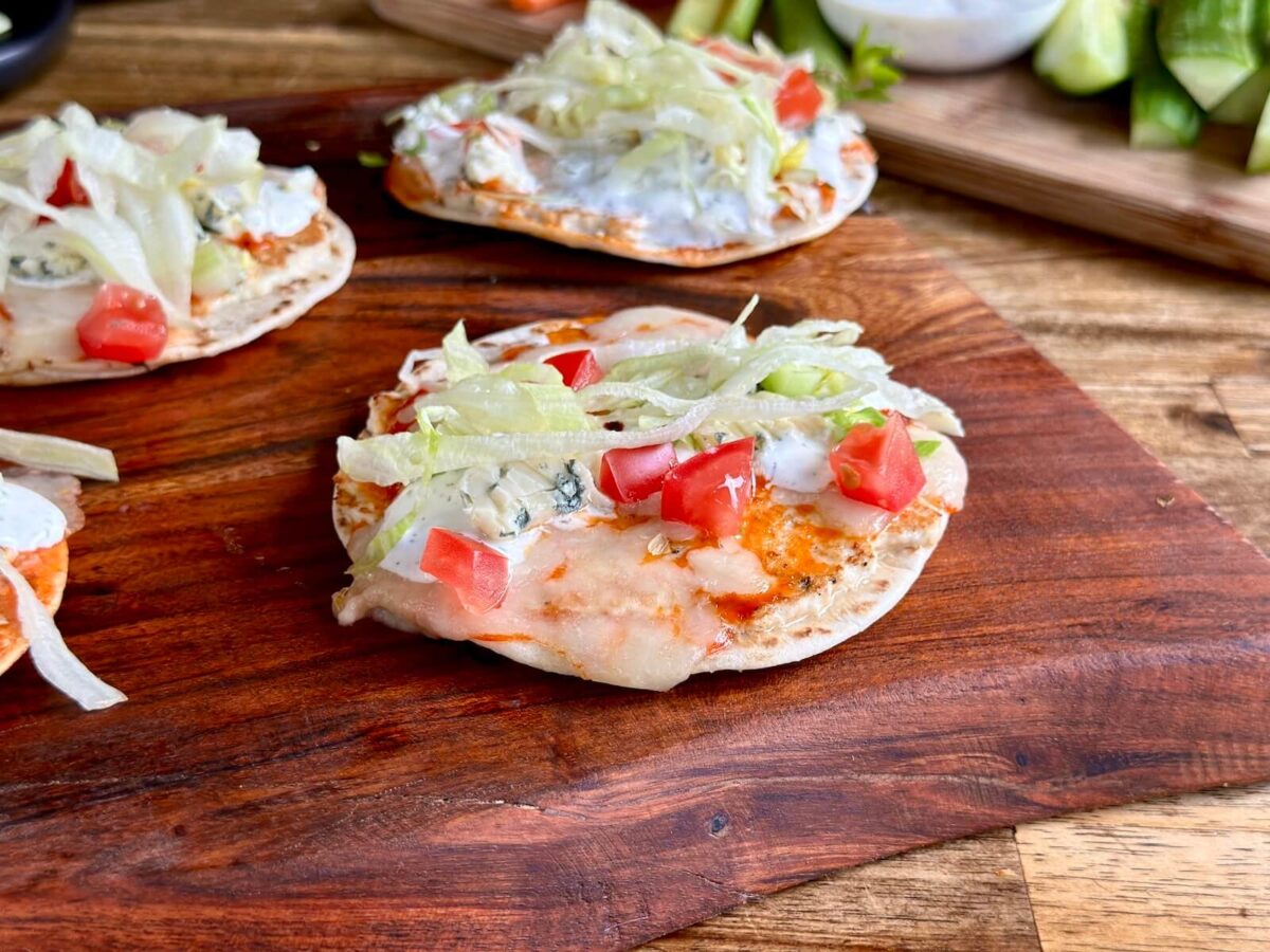 buffalo chicken smash tacos with ranch dressing, shredded lettuce, and diced tomatoes