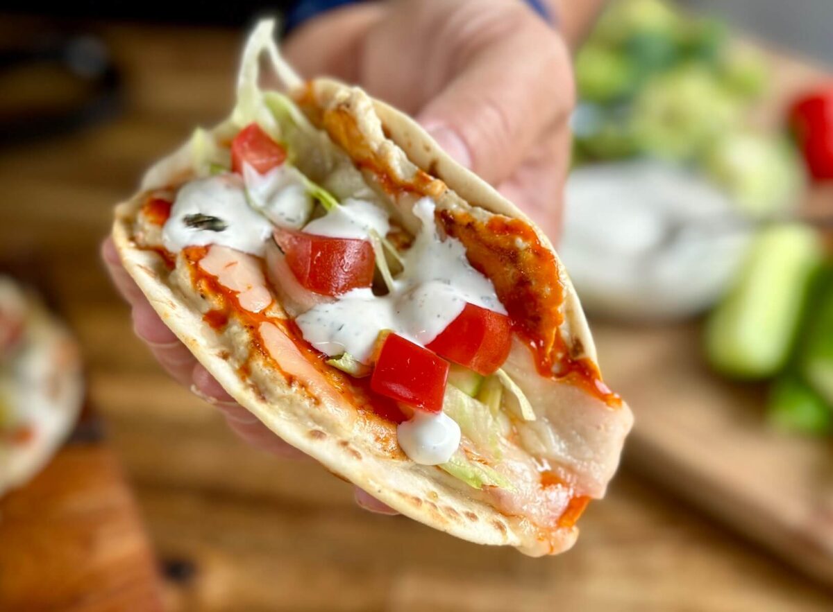 buffalo chicken smash taco with ranch dressing, shredded lettuce, and diced tomatoes