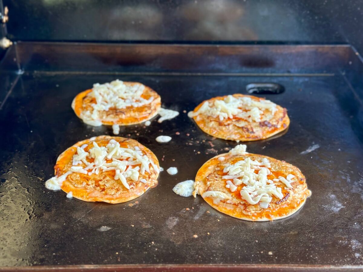 cooking buffalo chicken smash tacos on a griddle
