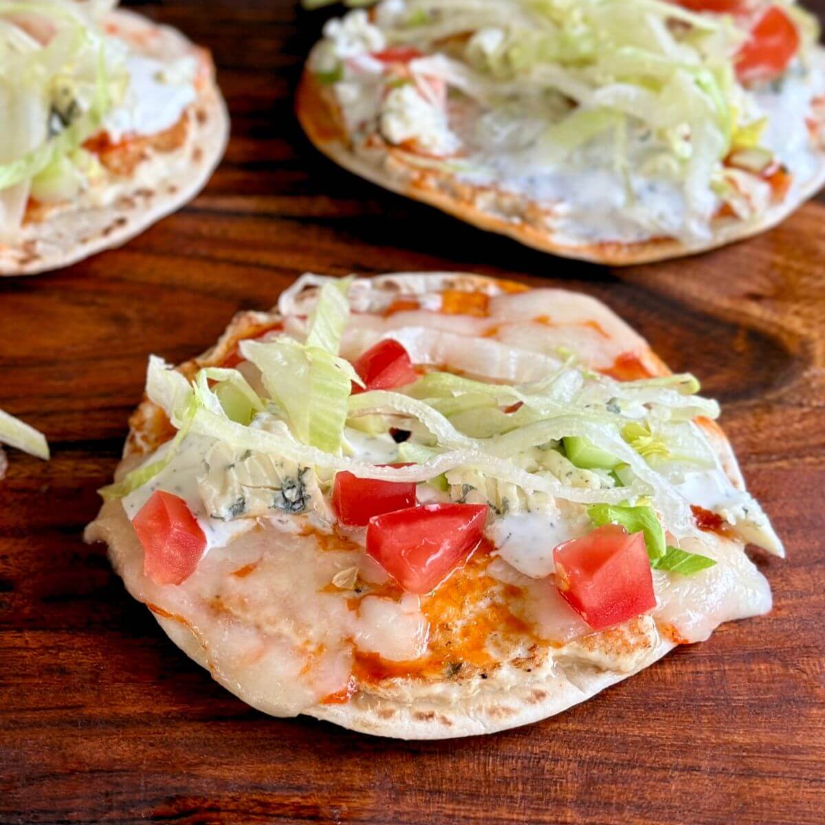 buffalo chicken smash tacos with ranch dressing, shredded lettuce, and diced tomatoes