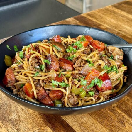 dirty spaghetti with ground beef, andouille sausage, and vegetables