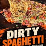 Dirty Spaghetti with sausage and ground beef being lifted from a Blackstone griddle, with text reading “Dirty Spaghetti—a viral recipe to make on the Blackstone.”